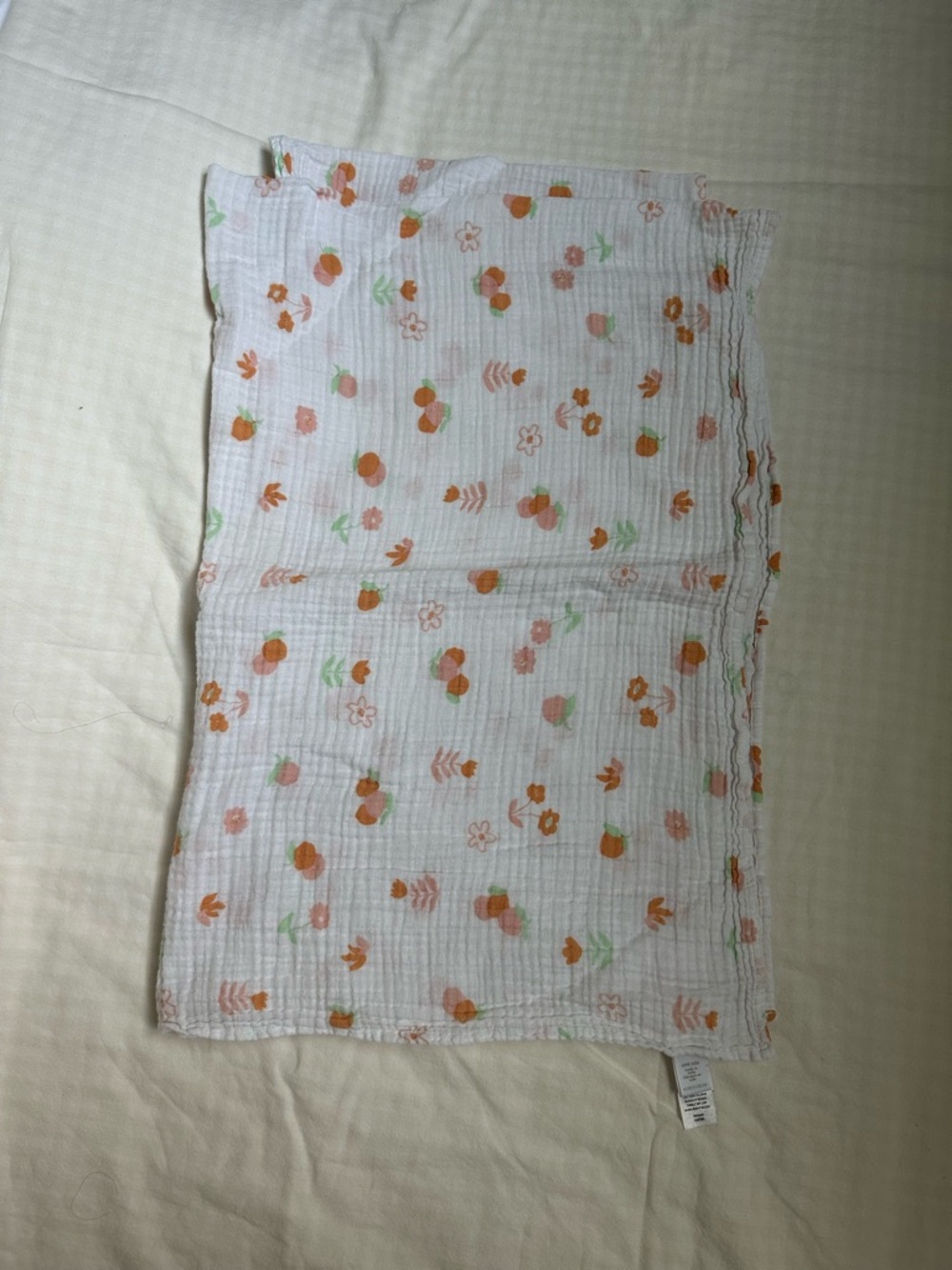 Nordstrom White Muslin Baby Swaddle with Orange and Green Floral Motif
